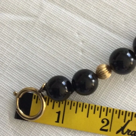 Woman’s Onyx Necklace Showcases a striking combination of black & gold bead